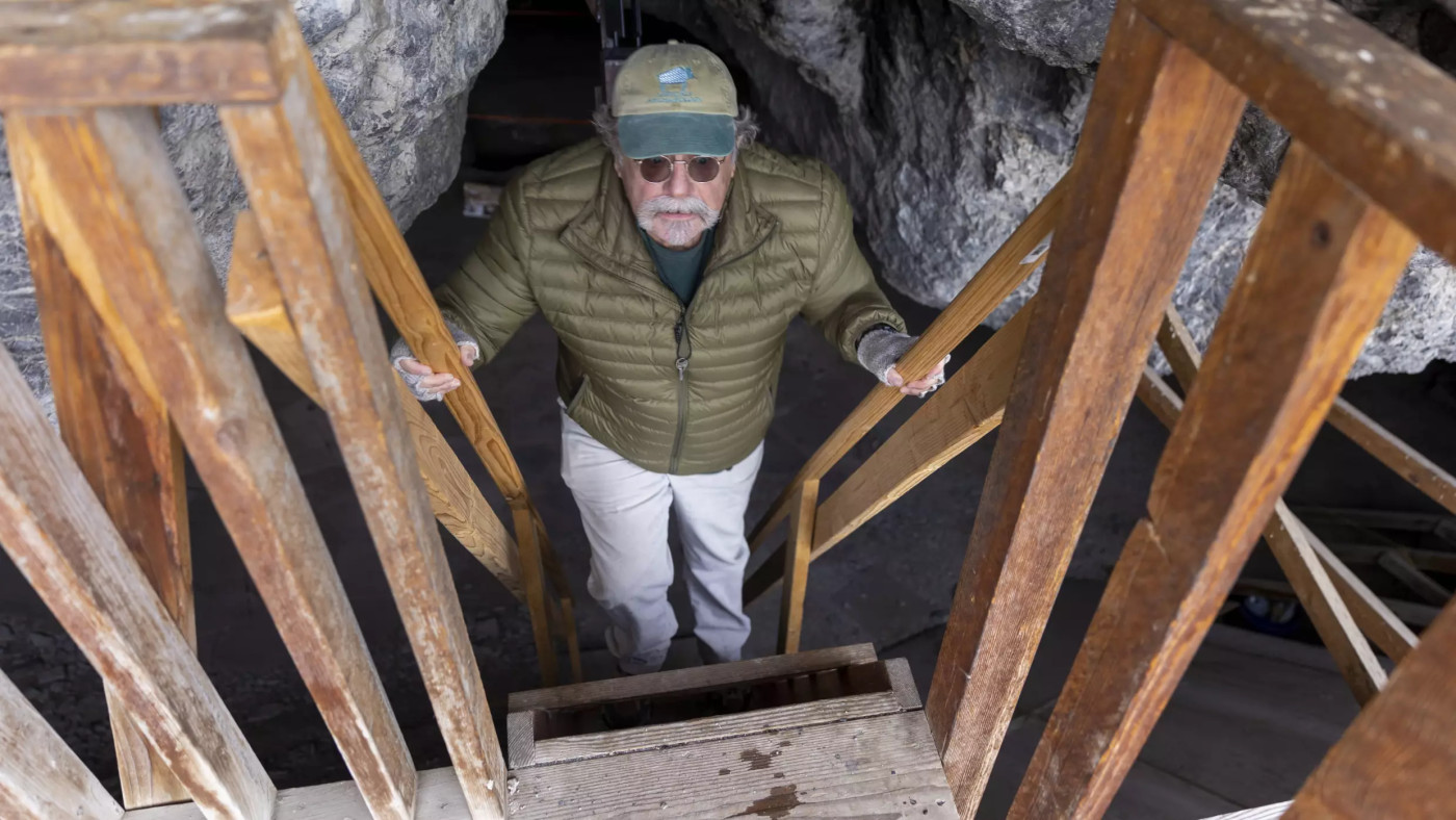 (Ben B. Braun, Deseret News) Archaeologist Ron Rood climbs down to the floor of Danger Cave in Tooele County on Sunday, Dec. 11, 2022.